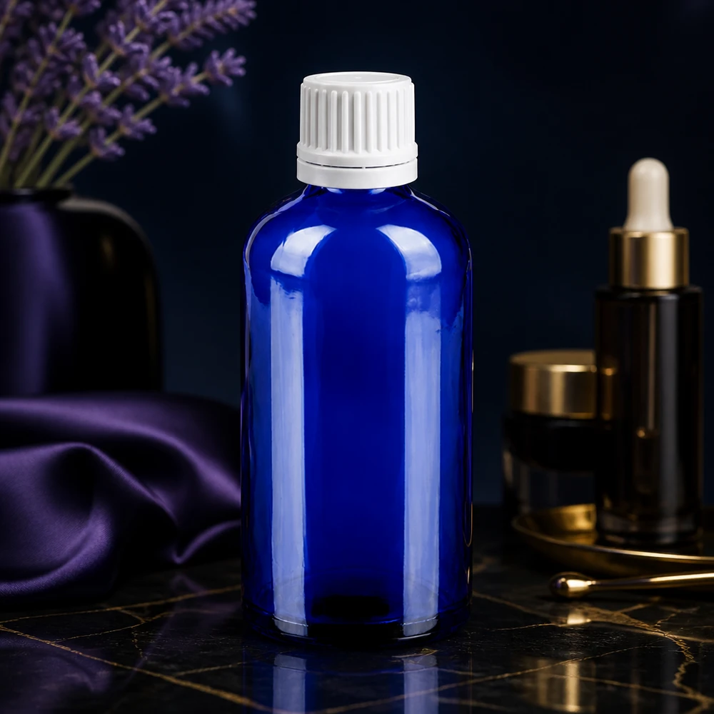 Nachfüllbare Tropfflasche 100ml aus recycelbarem blauen Glas mit auslaufsicherem weißem Verschluss