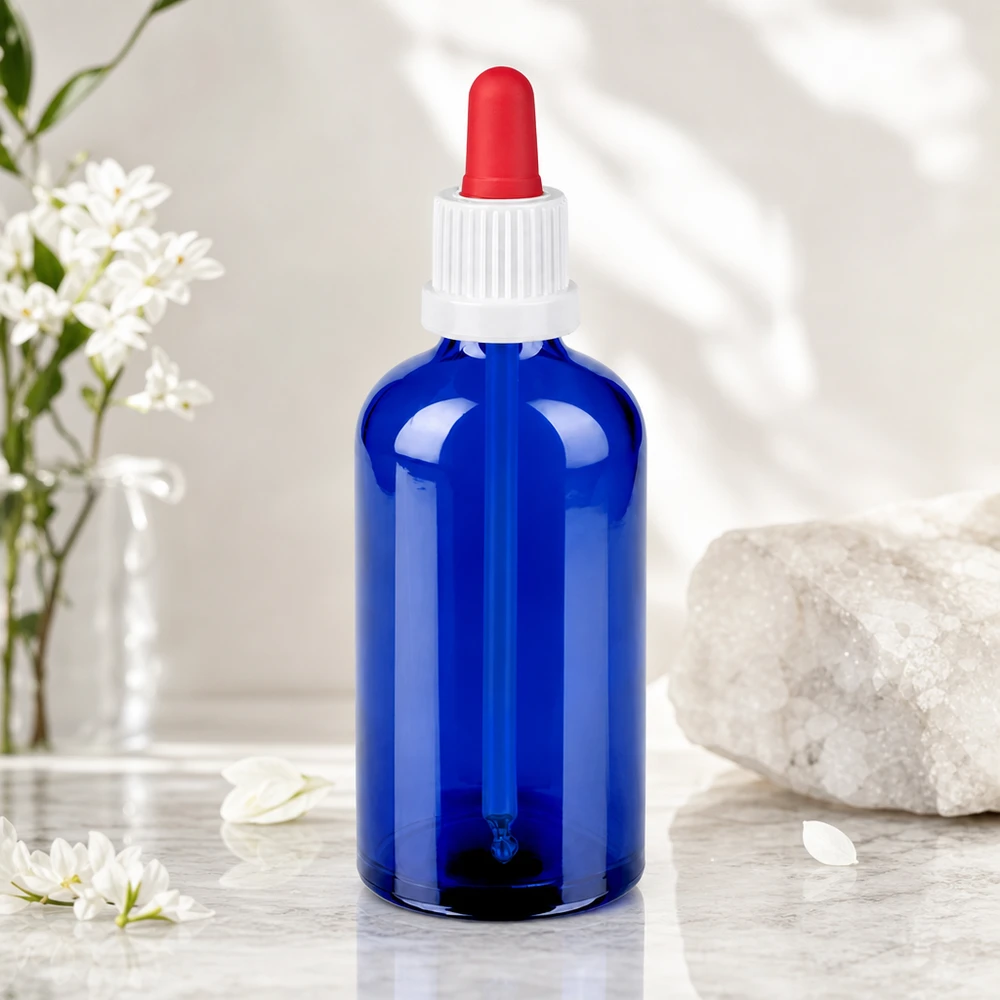 Stilvolle 100ml Glasflasche in Kobaltblau mit rotem Pipettenaufsatz für hochwertige Tinkturen