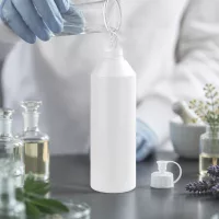 Semitransparente weiße HDPE Flasche 250ml mit weißem Spritzverschluss daneben auf Labortisch