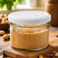 225ml Sturzglas BasicSeal gefüllt mit Nussbutter umgeben von Mandeln und Nüssen auf Holzuntergrund