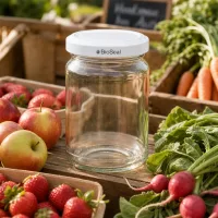 UNiTWIST Runda205 Einmachglas mit weißem TO58 BioSeal Deckel zwischen frischem Obst und Gemüse am Marktstand